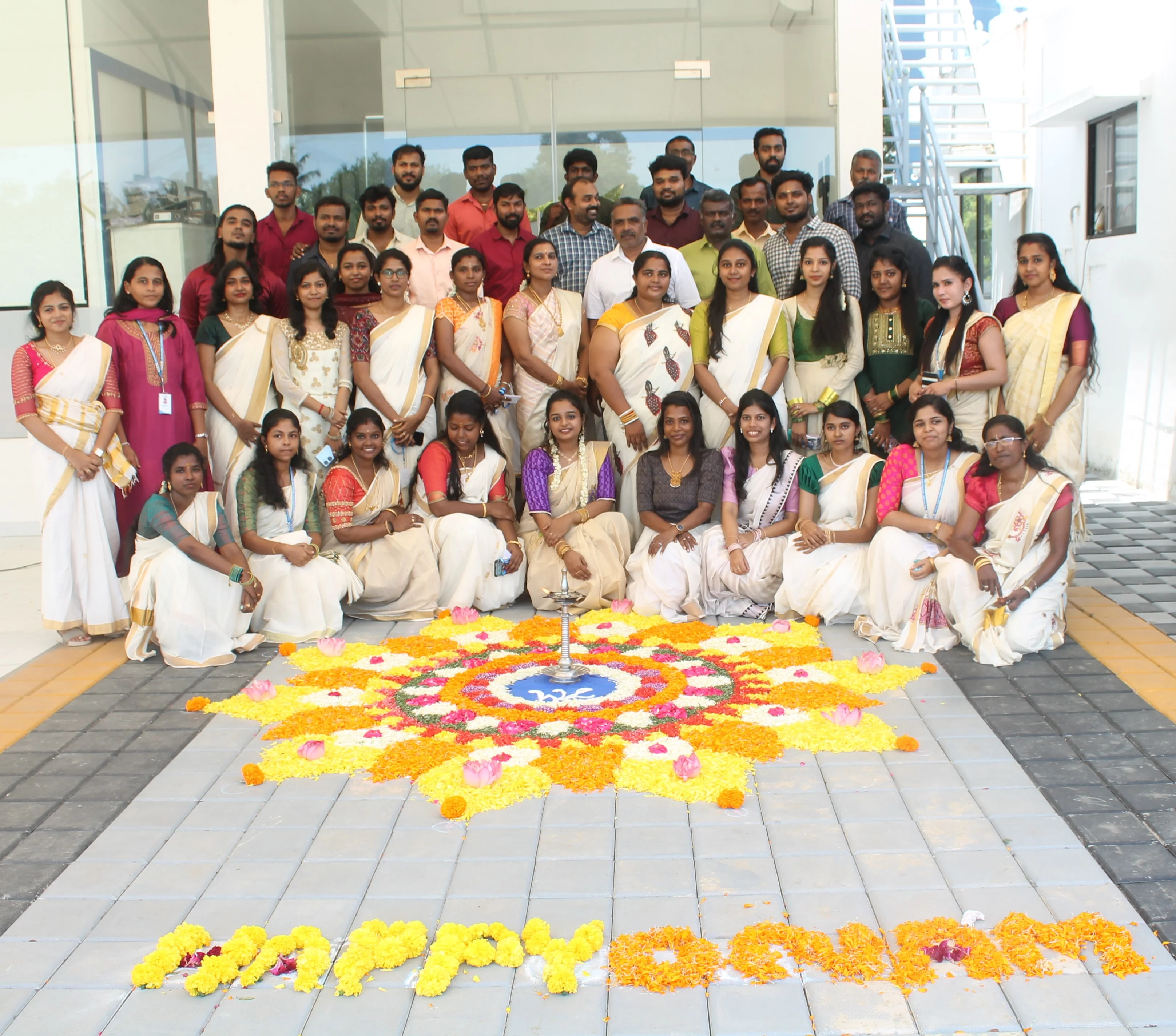 SubmitInMe office Onam celebration with traditional Pookalam and team members