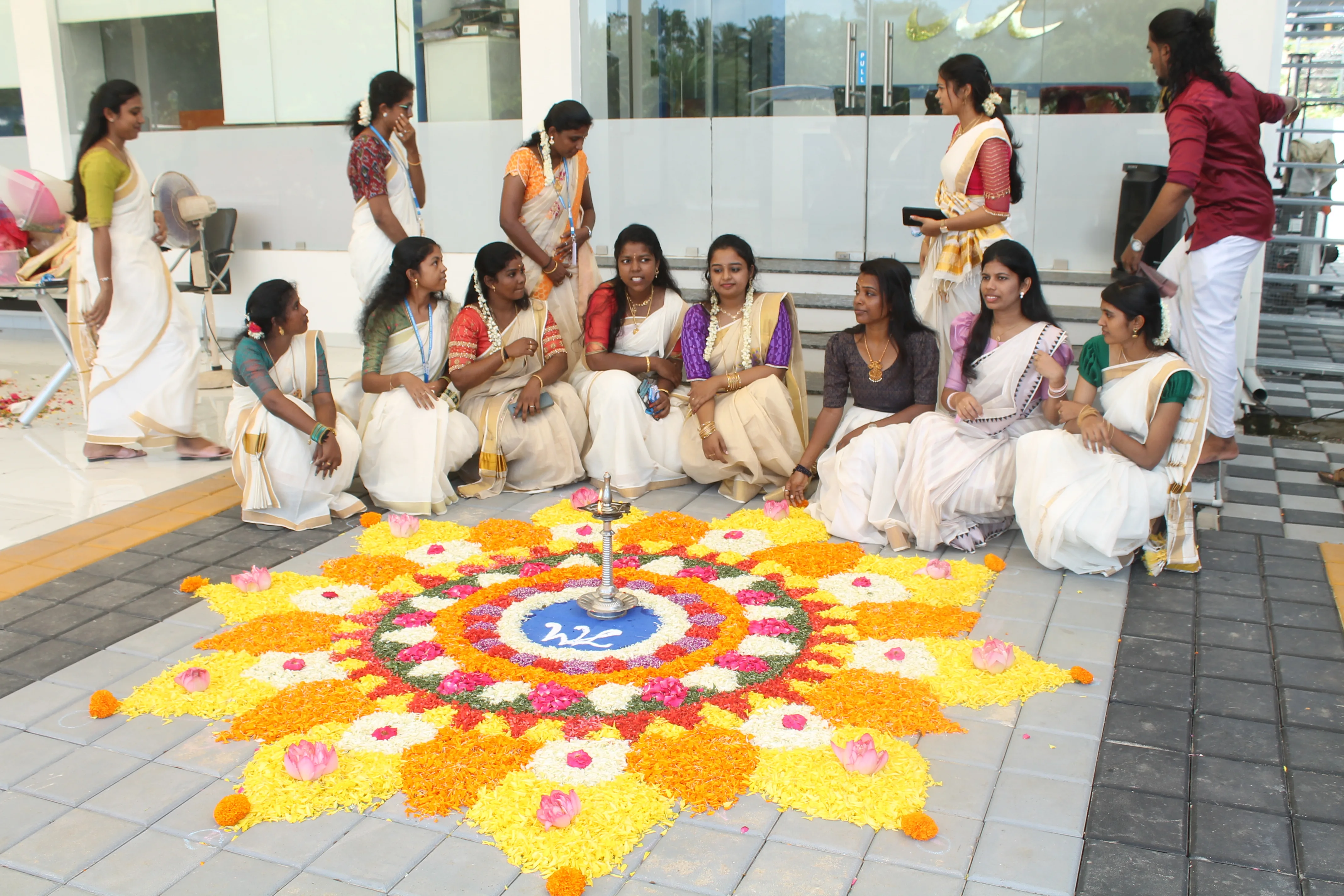 SubmitInMe SEO and digital marketing staff sitting around Pookalam during Onam festival